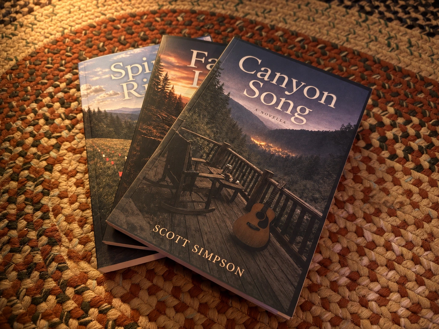 Canyon Song, Fault Line, and Spirit Rich books on a woven rug